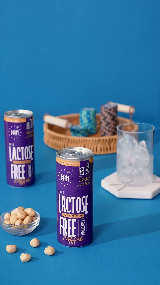 1AM Lactose Free cans set up with ice and hazelnuts